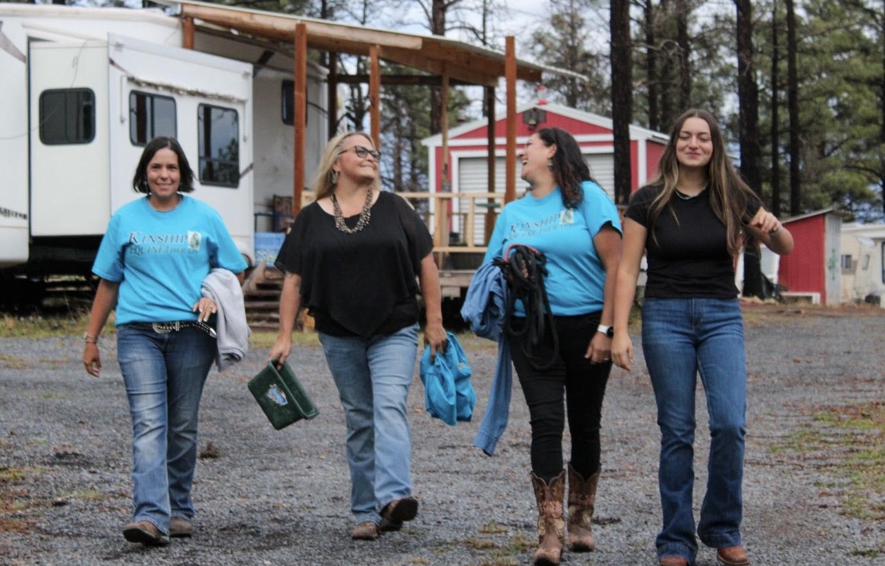 Four Kinship team members walking together at the ranch